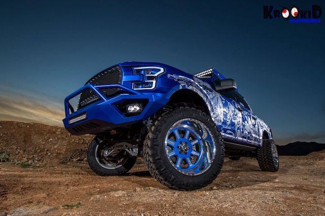 Custom blue wheels lifted Ford at dusk Custom blue wheels lifted Ford at dusk