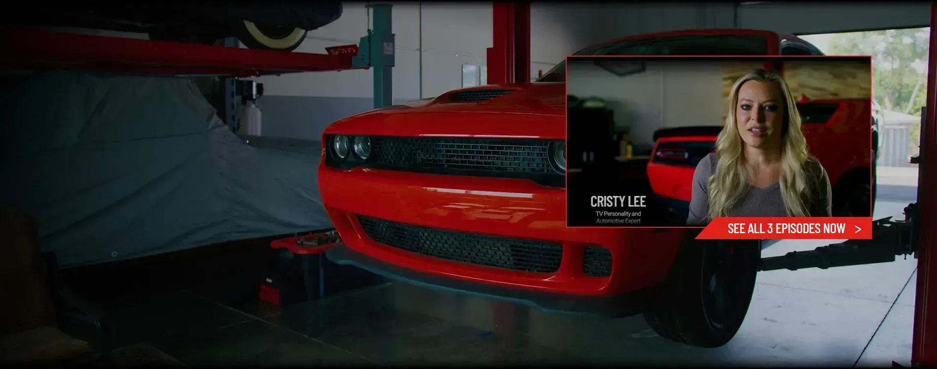 Rebuilding the Beast A Challenger Hellcat SRT car is elevated on a hydraulic lift inside a garage, with another covered vehicle in the background.