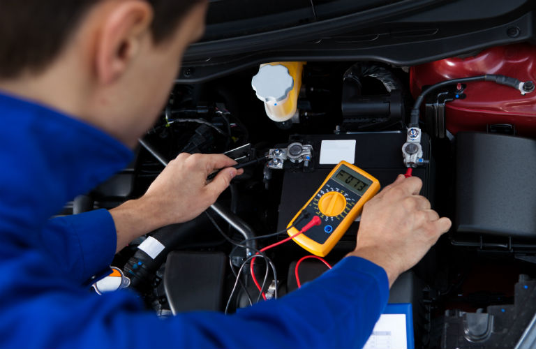 mechanic checking car battery