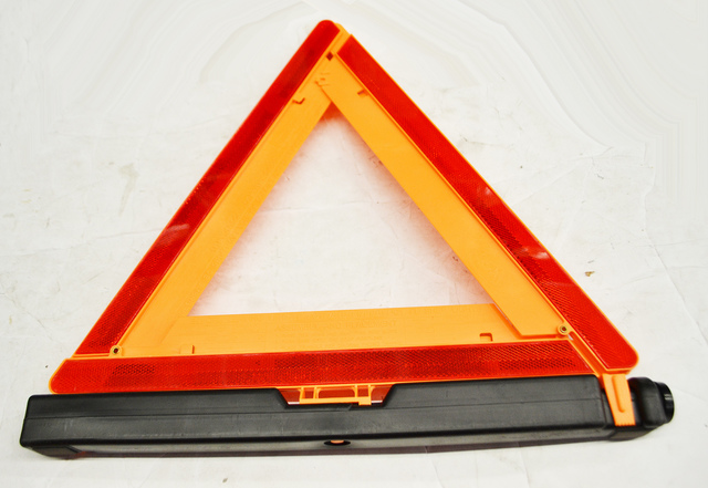 22745654 - Interior: Roadside Emergency Reflective Triangle for Buick: Enclave, Encore, Envision, LaCrosse, Regal Sportback, Regal TourX | Cadillac: ATS, CT4, CT5, CT6, CTS, DTS, ELR, Escalade, Escalade ESV, Escalade EXT, SRX, STS, XLR, XT4, XT5, XT6, XTS | Chevrolet: Avalanche, Avalanche 1500, Avalanche 2500, Blazer, Bolt EV, Camaro, Captiva Sport, Colorado, Corvette, Cruze, Equinox, Express 1500, Express 2500, Express 3500, Express 4500, Impala, Malibu, Silverado 1500, Silverado 1500 Classic, Silverado 1500 HD Classic, Silverado 1500 LD, Silverado 1500 LTD, Silverado 2500 HD, Silverado 2500 HD Classic, Silverado 3500 Classic, Silverado 3500 HD, Suburban, Suburban 1500, Suburban 2500, Suburban 3500 HD, Tahoe, Trailblazer, Traverse, Volt | GMC: Acadia, Acadia Limited, Canyon, Envoy, Savana 1500, Savana 2500, Savana 3500, Savana 4500, Sierra 1500, Sierra 1500 Classic, Sierra 1500 HD Classic, Sierra 1500 Limited, Sierra 2500 HD, Sierra 2500 HD Classic, Sierra 3500 Classic, Sierra 3500 HD, Terrain, Yukon, Yukon XL, Yukon XL 1500, Yukon XL 2500 Image