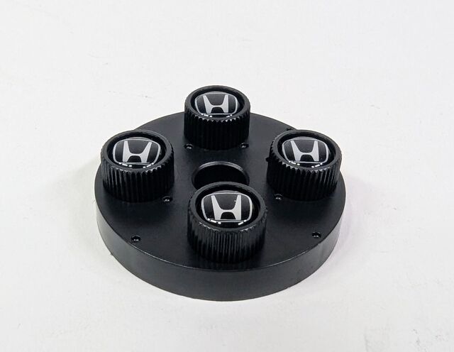 8W48PL4100A - Wheels: (H) Black Valve Stem Caps for Honda: Accord, Civic, Clarity, CR-V, Fit, HR-V, Insight, Odyssey, Passport, Pilot, Prologue, Ridgeline Image
