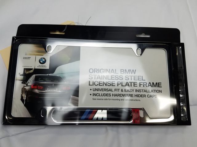 82120010405 - Exterior: M Logo License Plate Frame Chrome for BMW: 128i, 135i, 135is, 228i, 228i xDrive, 230i, 230i xDrive, 320i, 320i xDrive, 328d, 328d xDrive, 328i, 328i xDrive, 330e, 330i, 330i GT xDrive, 330i xDrive, 335i, 335i GT xDrive, 335i xDrive, 335is, 340i, 340i GT xDrive, 340i xDrive, 428i, 428i xDrive, 430i, 430i Gran Coupe, 430i xDrive, 435i, 435i xDrive, 440i, 440i xDrive, 528i, 528i xDrive, 530i, 530i xDrive, 535d, 535d xDrive, 535i, 535i GT, 535i GT xDrive, 535i xDrive, 540d xDrive, 540i, 540i xDrive, 550i, 550i GT xDrive, 550i xDrive, 640i, 640i Gran Coupe, 640i xDrive, 640i xDrive Gran Coupe, 640i xDrive Gran Turismo, 650i, 650i Gran Coupe, 650i xDrive, 650i xDrive Gran Coupe, 740e xDrive, 740i, 740i xDrive, 740Li, 740Li xDrive, 750i, 750i xDrive, 750Li, 750Li xDrive, 760Li, 840i, 840i Gran Coupe, Alpina B6 xDrive Gran Coupe, Alpina B7, M2, M235i, M235i xDrive, M240i, M240i xDrive, M3, M340i, M4, M440i Gran Coupe, M5, M550i xDrive, M6, M6 Gran Coupe, M760i xDrive, M8, X1, X2, X3, X4, X5, X6, X7, Z4 Image