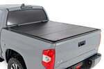 49414551 - : Hard Tri-Fold Flip Up Bed Cover | 5'7" Bed | Fits Toyota Tundra 2WD/4WD (07-21) for Rough Country Image