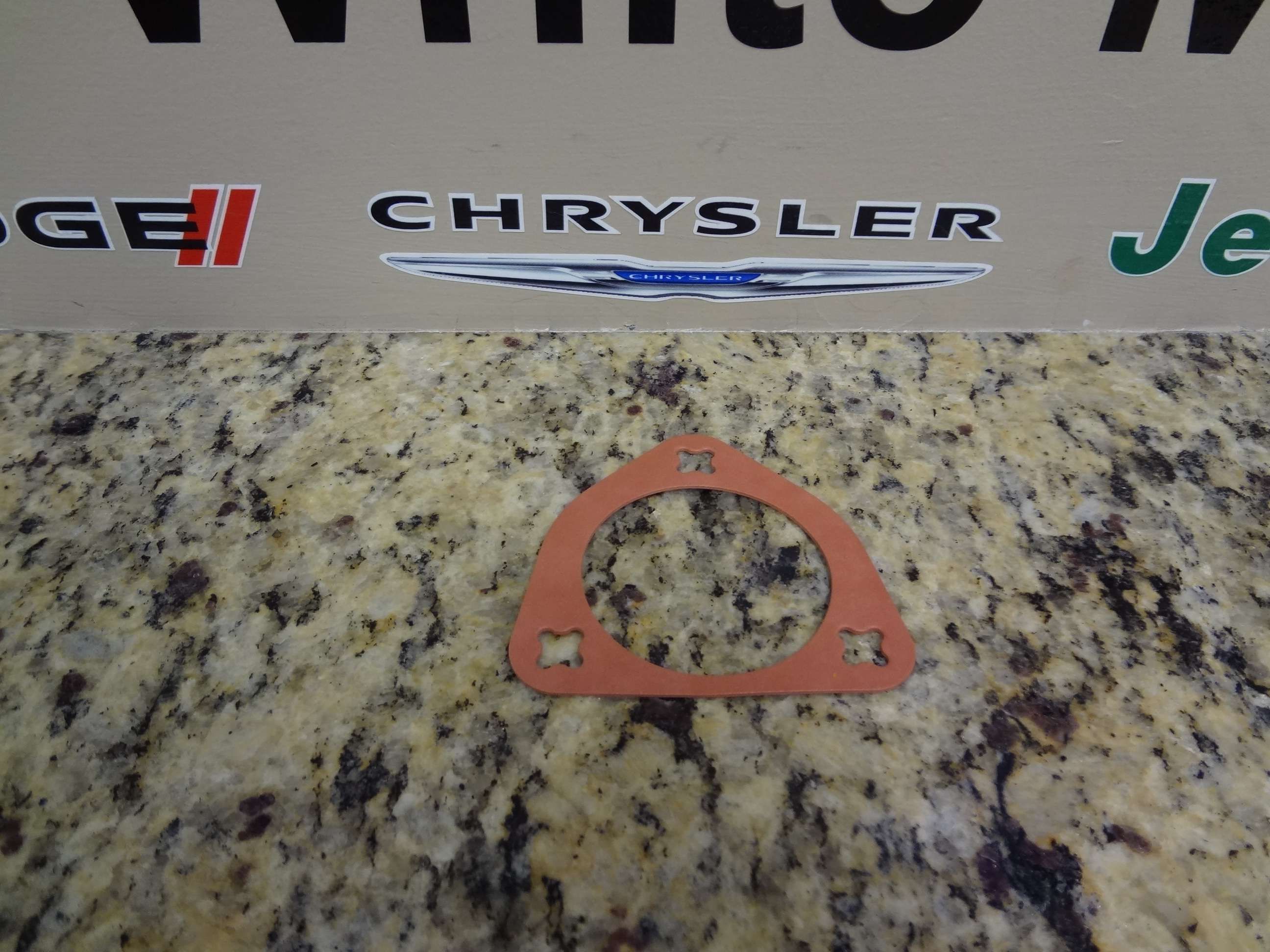 4536492AB - Engine 3.5L Six Cylinder: Camshaft Thrust Seal for Chrysler: 300, 300M, Concorde, Pacifica, Sebring, Town &amp; Country | Dodge: Avenger, Challenger, Charger, Grand Caravan, Intrepid, Journey, Magnum, Nitro Image