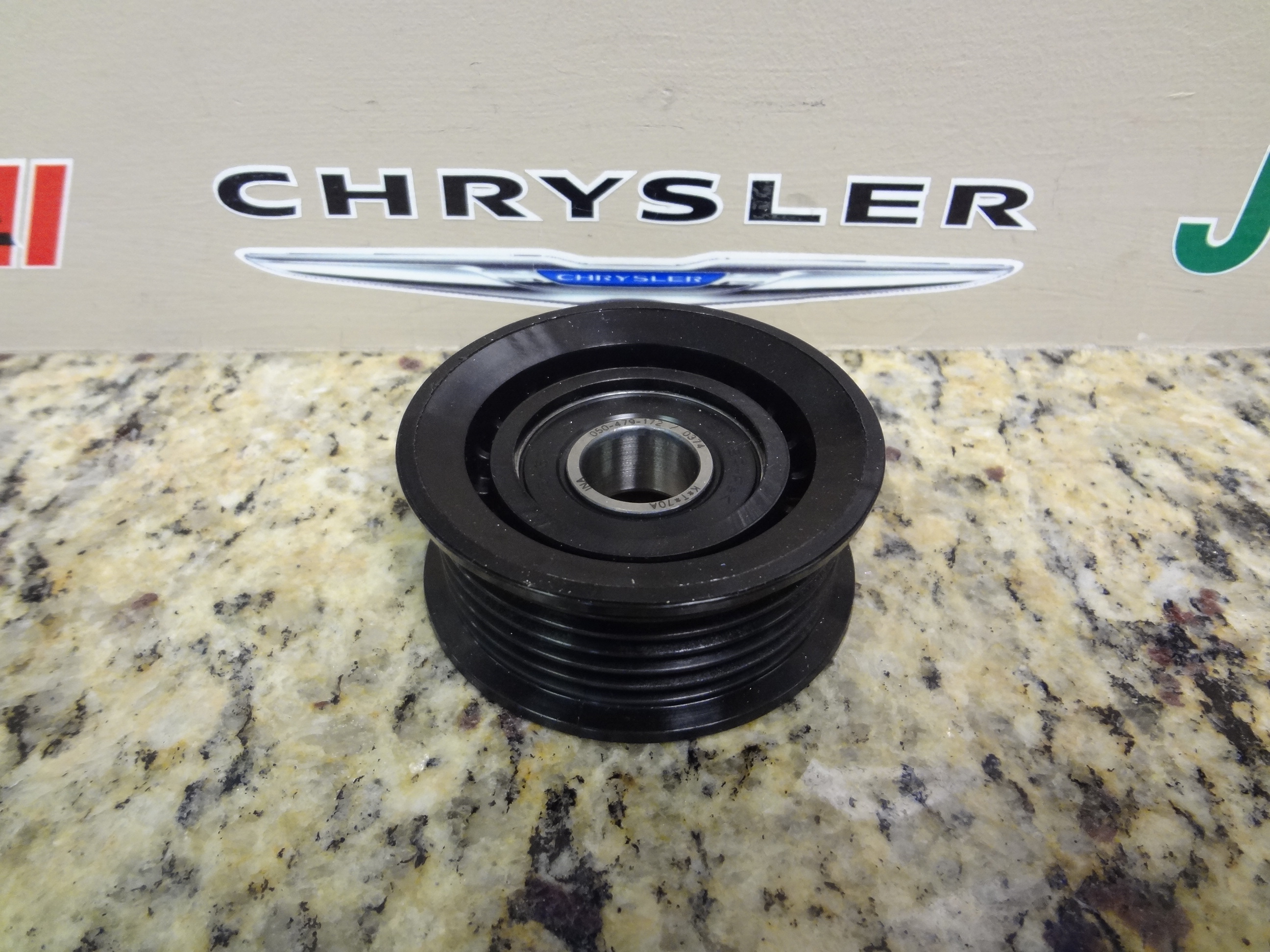 4627851AA - Cooling: Idler Pulley for Chrysler: 300 | Dodge: Challenger, Charger, Dart, Durango, Magnum | Jeep: Cherokee, Grand Cherokee, Grand Cherokee L, Wrangler | Ram: 1500, 1500 Classic Image