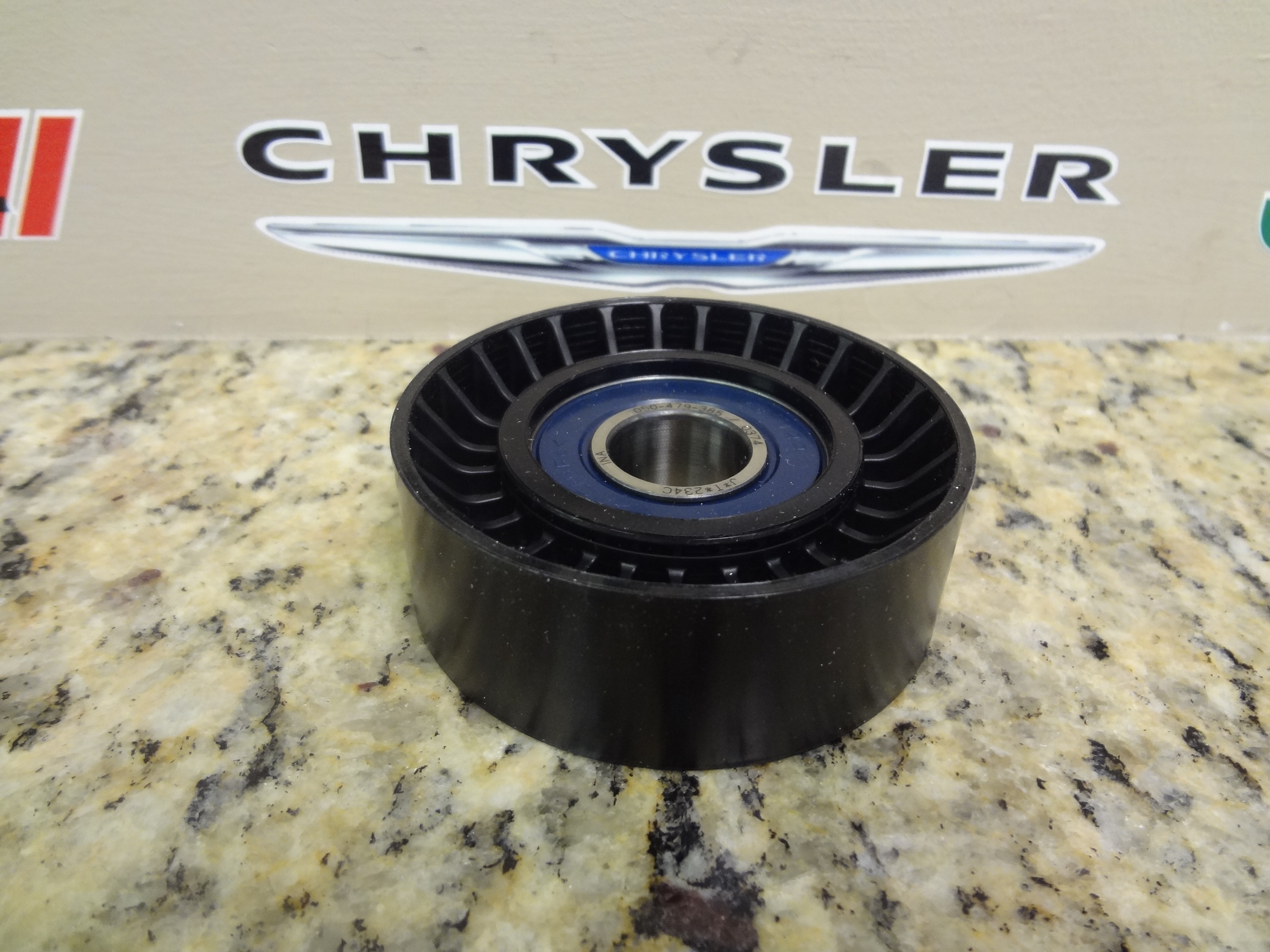 4891720AA - Cooling: Idler Pulley for Chrysler: 300, Aspen, Pacifica, Sebring, Town &amp; Country | Dodge: Avenger, Challenger, Charger, Durango, Grand Caravan, Journey, Magnum, Nitro, Ram 1500, Ram 2500, Ram 3500 | Jeep: Commander, Grand Cherokee, Grand Cherokee L, Wrangler | Ram: 1500, 1500 Classic, 2500, 3500 Image