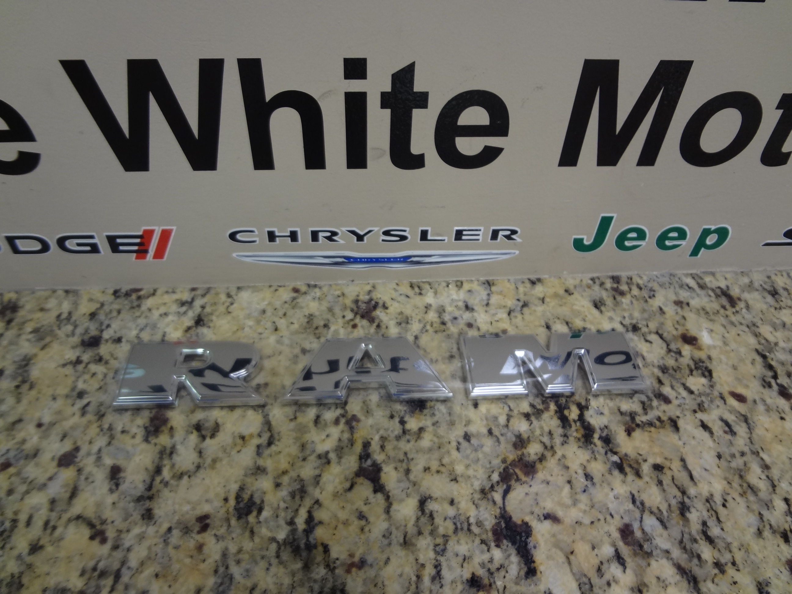 55277434AB - Exterior Ornamentation: Front Door Nameplate for Dodge: Ram 1500 | Ram: 1500, 1500 Classic Image