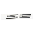 5152006AA - Exterior Ornamentation: Se Nameplate for Chrysler: 300M, Concorde, Sebring, Town &amp; Country, Voyager | Dodge: Caravan, Grand Caravan, Intrepid, Stratus Image