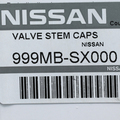 999MBSX000 - Exterior: Tire Valve Stem Caps/ Nissan Logo'd for Nissan: 200SX, 240SX, 300ZX, 350Z, 370Z, Altima, Armada, Axxess, Cube, Frontier, GT-R, Juke, Kicks, LEAF, Maxima, Murano, NV1500, NV200, NV2500, NV3500, NX, Pathfinder, Pickup, Pulsar NX, Quest, Rogue, Rogue Sport, Sentra, Stanza, TITAN, TITAN XD, Versa, Versa Note, Xterra Image