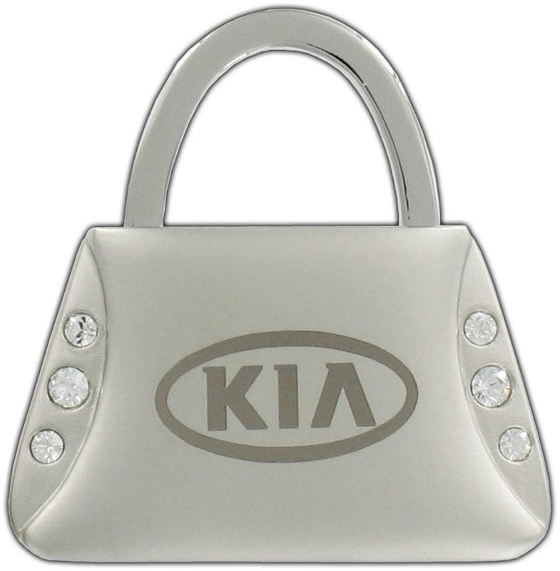 UM090AY701 - Keychain: OEM NEW 10-20 Kia Forte Handbag Purse Keychain "KIA" Logo w/ Crystals UM090AY701 for Kia: Amanti, Borrego, Cadenza, Carnival, Forte, Forte Koup, Forte5, K5, K900, Niro, Niro EV, Optima, Rio, Rio5, Rondo, Sedona, Seltos, Sorento, Soul, Soul EV, Spectra, Spectra5, Sportage, Stinger, Telluride Image