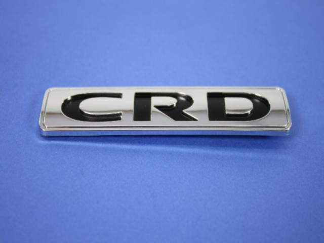 4806209AA - Exterior Ornamentation: Nameplate for Chrysler: 300, Town &amp; Country | Dodge: Avenger, Caliber, Charger, Grand Caravan, Journey, Magnum, Nitro | Ram: C/V Image