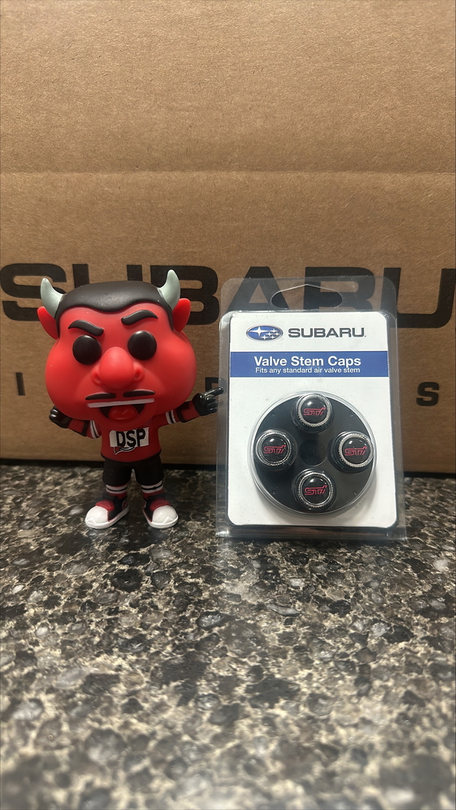 SOA342L136 - Wheels: Valve Stem Caps - Sti Logo for Subaru: BRZ, Crosstrek, Forester, Impreza, Legacy, Outback, Tribeca, WRX Image