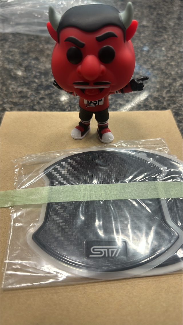 J1210SJ500 - Exterior: Door Handle Cup Protector - Sti Logo for Subaru: Crosstrek, Forester, Impreza, WRX Image