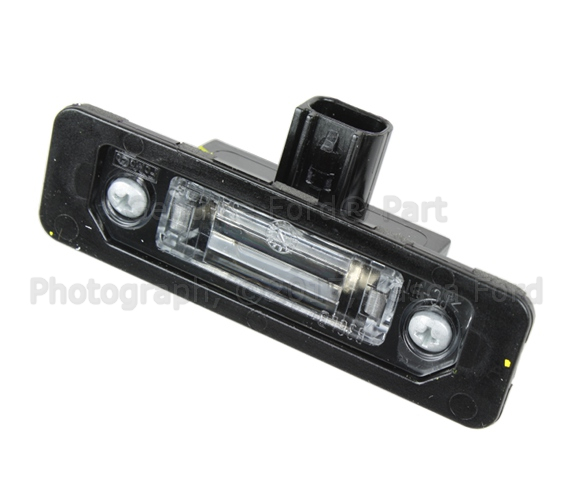8T5Z13550B - Electrical: License Lamp for Ford: Flex, Focus, Fusion, Mustang, Police Interceptor Sedan, Special Service Police Sedan, Taurus | Lincoln: MKS, MKT, MKX, MKZ, Zephyr | Mercury: Milan, Sable Image