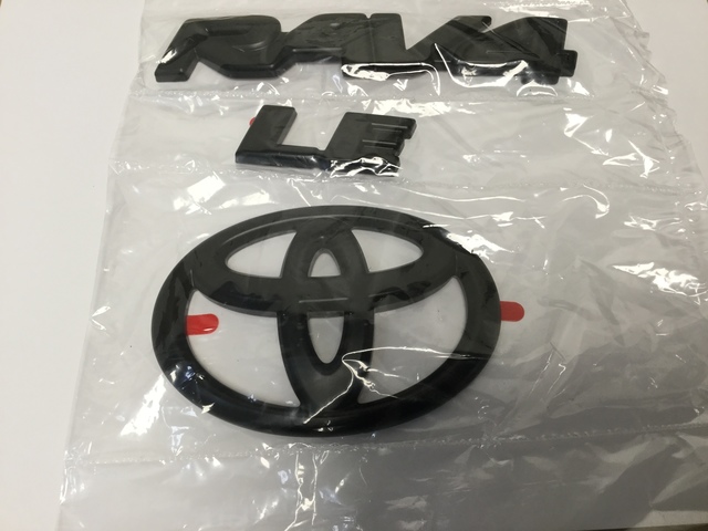 PT9484219402 - Exterior: Exterior Emblem Blackout Overlay, LE Model (Toyota Rav4) Genuine Toyota Accessories - New - for Toyota: RAV4, RAV4 Prime Image