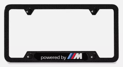 82125A1C497 - Exterior: 2016-2025 BMW - License Plate Frame, Powered By M for BMW: 230i, 320i, 328d, 330e, 330i, 330i GT xDrive, 340i, 340i GT xDrive, 430i, 430i Gran Coupe, 440i, 530i, 535i GT, 540i, 550i GT xDrive, 640i, 640i Gran Coupe, 640i xDrive Gran Turismo, 650i, 650i Gran Coupe, 740i, 750i, 840i, 840i Gran Coupe, Alpina B6 xDrive Gran Coupe, Alpina B7, M2, M240i, M3, M340i, M4, M440i Gran Coupe, M5, M550i xDrive, M6, M6 Gran Coupe, M760i xDrive, M8, X1, X2, X3, X4, X5, X6, X7, Z4 Image