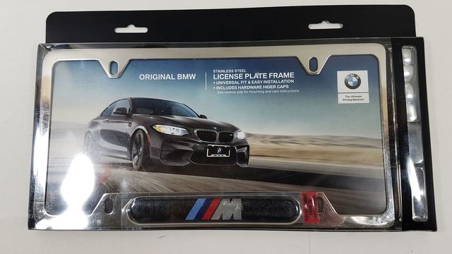 82120010405 - Exterior: M Logo Stainless Steel License Plate Frame for BMW: 128i, 135i, 135is, 228i, 228i xDrive, 230i, 230i xDrive, 320i, 320i xDrive, 328d, 328d xDrive, 328i, 328i xDrive, 330e, 330i, 330i GT xDrive, 330i xDrive, 335i, 335i GT xDrive, 335i xDrive, 335is, 340i, 340i GT xDrive, 340i xDrive, 428i, 428i xDrive, 430i, 430i Gran Coupe, 430i xDrive, 435i, 435i xDrive, 440i, 440i xDrive, 528i, 528i xDrive, 530i, 530i xDrive, 535d, 535d xDrive, 535i, 535i GT, 535i GT xDrive, 535i xDrive, 540d xDrive, 540i, 540i xDrive, 550i, 550i GT xDrive, 550i xDrive, 640i, 640i Gran Coupe, 640i xDrive, 640i xDrive Gran Coupe, 640i xDrive Gran Turismo, 650i, 650i Gran Coupe, 650i xDrive, 650i xDrive Gran Coupe, 740e xDrive, 740i, 740i xDrive, 740Li, 740Li xDrive, 750i, 750i xDrive, 750Li, 750Li xDrive, 760Li, 840i, 840i Gran Coupe, Alpina B6 xDrive Gran Coupe, Alpina B7, M2, M235i, M235i xDrive, M240i, M240i xDrive, M3, M340i, M4, M440i Gran Coupe, M5, M550i xDrive, M6, M6 Gran Coupe, M760i xDrive, M8, X1, X2, X3, X4, X5, X6, X7, Z4 Image