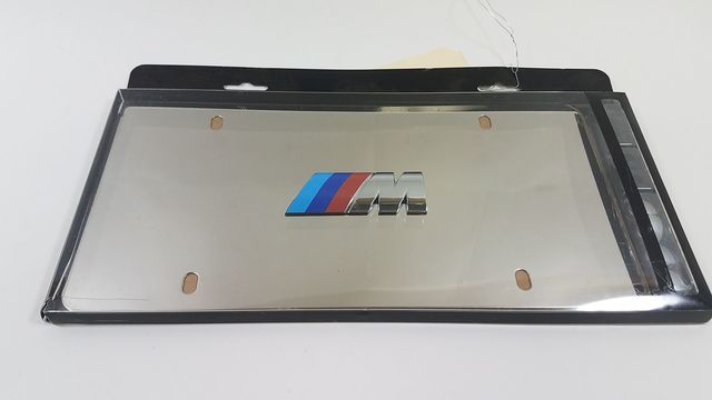 82121470398 - Exterior: Stainless Steel M Logo Marque Plate for BMW: 128i, 135i, 135is, 228i, 228i xDrive, 230i, 230i xDrive, 320i, 320i xDrive, 328d, 328d xDrive, 328i, 328i xDrive, 330e, 330i, 330i GT xDrive, 330i xDrive, 335i, 335i GT xDrive, 335i xDrive, 335is, 340i, 340i GT xDrive, 340i xDrive, 428i, 428i xDrive, 430i, 430i xDrive, 435i, 435i xDrive, 440i, 440i xDrive, 528i, 528i xDrive, 530i, 530i xDrive, 535d, 535d xDrive, 535i, 535i GT, 535i GT xDrive, 535i xDrive, 540d xDrive, 540i, 540i xDrive, 550i, 550i GT xDrive, 550i xDrive, 640i, 640i Gran Coupe, 640i xDrive, 640i xDrive Gran Coupe, 640i xDrive Gran Turismo, 650i, 650i Gran Coupe, 650i xDrive, 650i xDrive Gran Coupe, 740e xDrive, 740i, 740i xDrive, 740Li, 740Li xDrive, 750i, 750i xDrive, 750Li, 750Li xDrive, 760Li, 840i, Alpina B6 xDrive Gran Coupe, Alpina B7, M2, M235i, M235i xDrive, M240i, M240i xDrive, M3, M340i, M4, M5, M550i xDrive, M6, M6 Gran Coupe, M760i xDrive, M8, X1, X2, X3, X4, X5, X6, X7, Z4 Image