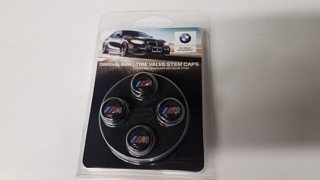 36122456427 - Wheels: Bmw M Valve Stem Caps - Black for BMW: 230i, 230i xDrive, 320i, 320i xDrive, 328d, 328d xDrive, 330e, 330i, 330i GT xDrive, 330i xDrive, 340i, 340i GT xDrive, 340i xDrive, 430i, 430i Gran Coupe, 430i xDrive, 440i, 440i xDrive, 530i, 530i xDrive, 540d xDrive, 540i, 540i xDrive, 640i, 640i Gran Coupe, 640i xDrive, 640i xDrive Gran Coupe, 640i xDrive Gran Turismo, 650i, 650i Gran Coupe, 650i xDrive, 650i xDrive Gran Coupe, 740i, 740i xDrive, 750i, 750i xDrive, 840i, 840i Gran Coupe, Alpina B6 xDrive Gran Coupe, Alpina B7, M2, M240i, M240i xDrive, M3, M340i, M4, M440i Gran Coupe, M5, M550i xDrive, M6, M6 Gran Coupe, M760i xDrive, M8, X1, X2, X3, X4, X5, X6, X7, Z4 Image
