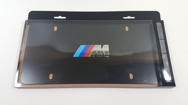 82121470397 - Exterior: Marque Plate - M Logo - Black Stainless Steel for BMW: 128i, 135i, 135is, 228i, 228i xDrive, 230i, 230i xDrive, 320i, 320i xDrive, 328d, 328d xDrive, 328i, 328i xDrive, 330e, 330i, 330i GT xDrive, 330i xDrive, 335i, 335i GT xDrive, 335i xDrive, 335is, 340i, 340i GT xDrive, 340i xDrive, 428i, 428i xDrive, 430i, 430i xDrive, 435i, 435i xDrive, 440i, 440i xDrive, 528i, 528i xDrive, 530i, 530i xDrive, 535d, 535d xDrive, 535i, 535i GT, 535i GT xDrive, 535i xDrive, 540d xDrive, 540i, 540i xDrive, 550i, 550i GT xDrive, 550i xDrive, 640i, 640i Gran Coupe, 640i xDrive, 640i xDrive Gran Coupe, 640i xDrive Gran Turismo, 650i, 650i Gran Coupe, 650i xDrive, 650i xDrive Gran Coupe, 740e xDrive, 740i, 740i xDrive, 740Li, 740Li xDrive, 750i, 750i xDrive, 750Li, 750Li xDrive, 760Li, 840i, Alpina B6 xDrive Gran Coupe, Alpina B7, M2, M235i, M235i xDrive, M240i, M240i xDrive, M3, M340i, M4, M5, M550i xDrive, M6, M6 Gran Coupe, M760i xDrive, M8, X1, X2, X3, X4, X5, X6, X7, Z4 Image