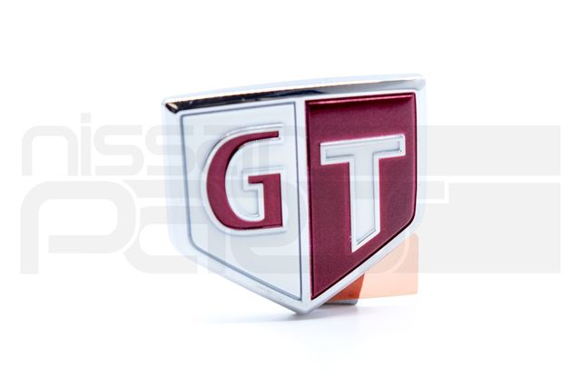 63896AA100 - : "GT" FRONT FENDER EMBLEM (RED / WHITE) (R34) for Nismo Image