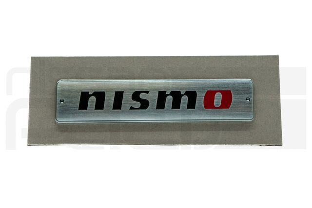 99993RN201 - : NISMO BADGE (METAL) (Z33 FAIRLADY) for Nissan: 200SX, 240SX, 280ZX, 300ZX, 310, 350Z, 720, Altima, Armada, Axxess, Cube, Frontier, GT-R, Juke, Kicks, Maxima, Murano, NV1500, NV200, NV2500, NV3500, Pathfinder, Pathfinder Armada, Pulsar NX, Quest, Rogue, Rogue Select, Sentra, Stanza, TITAN, TITAN XD, Van, Versa, Versa Note, Xterra Image