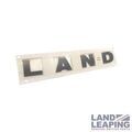 DAB500050LQV - : Hood Emblem - "LAND" portion for Land Rover: LR3, LR4 Image