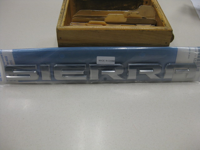 15129653 - Accessories: Tailgate Emblem for Chevrolet: Silverado 1500, Silverado 1500 LD, Silverado 2500 HD, Silverado 3500 HD | GMC: Sierra 1500, Sierra 1500 Limited, Sierra 2500 HD, Sierra 3500 HD Image