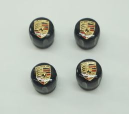 99104460267 - Wheels: Porsche Black Decorative Valve Sleeves With Color Crest for Porsche: 718 Boxster, 718 Cayman, 718 Spyder, 911, Cayenne, Cayman, Macan, Panamera, Taycan Image